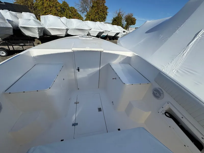 Slide: The Image of 1999 Marlin 350 SF boat interior with storage compartments, docked outdoors. - 11
