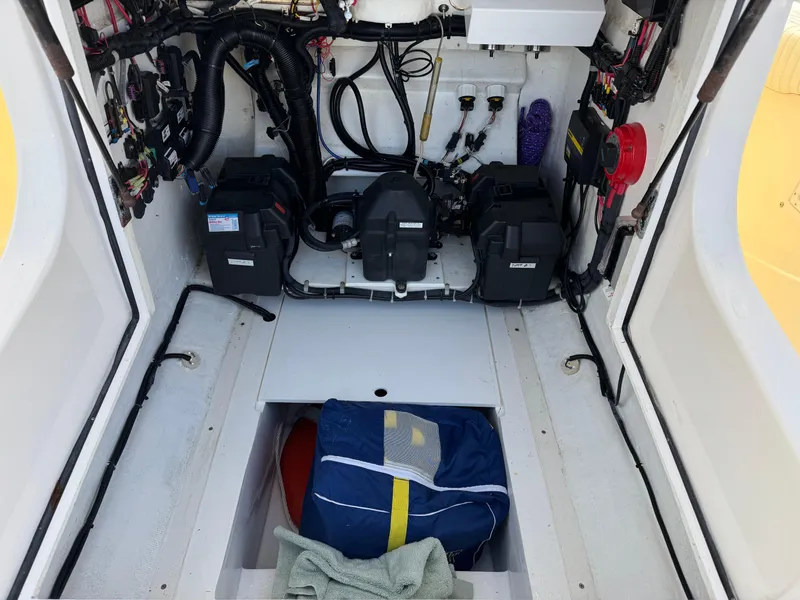 Slide: The Image of 1999 Marlin 350 SF boat interior with organized wiring and storage compartment. - 13
