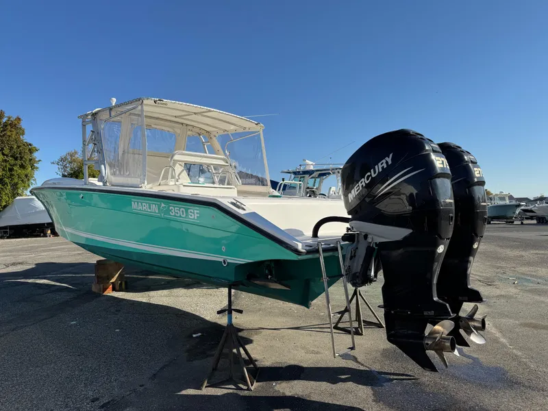 Slide: The Image of 1999 Marlin 350 SF boat with twin Mercury engines on display. - 2