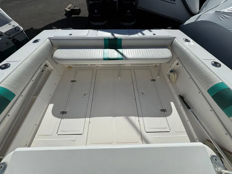 Slide: The Image of 1999 Marlin 350 SF boat interior with cushioned seating and storage compartments. - 24