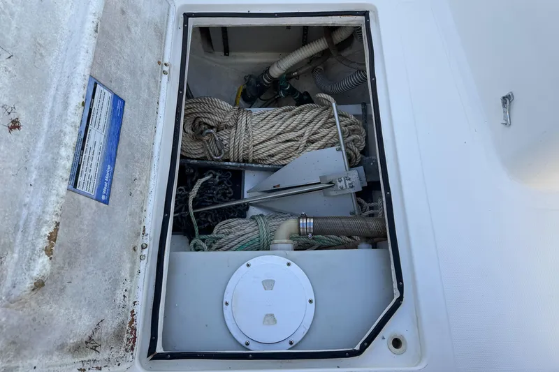 Slide: The Image of 1999 Marlin 350 SF boat storage compartment with ropes and anchor. - 9