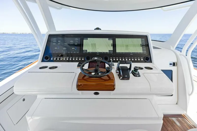 Slide: The Image of 2024 Valhalla V55 boat helm with advanced navigation displays and controls. - 15