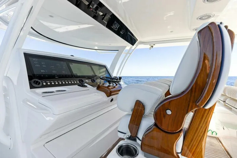 Slide: The Image of 2024 Valhalla V55 boat helm with luxurious seating and advanced navigation controls. - 16