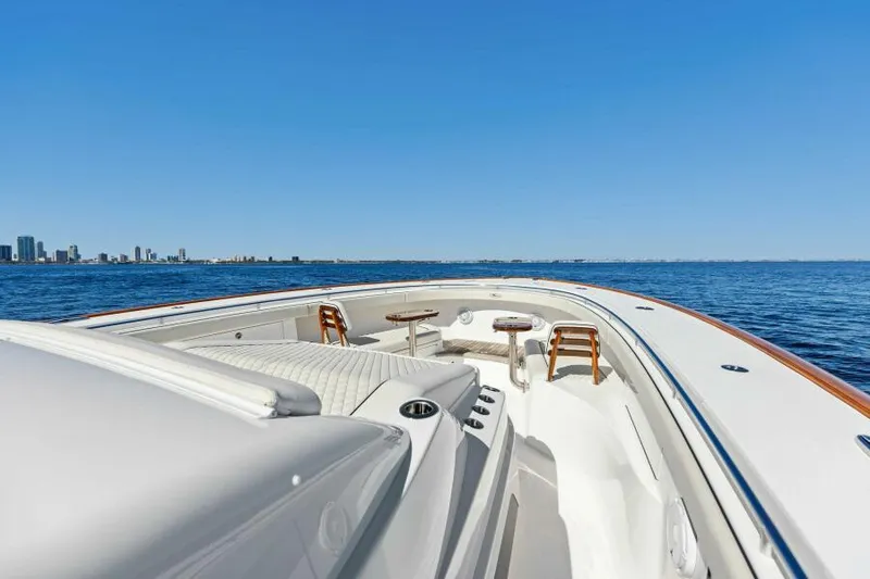 Slide: The Image of 2024 Valhalla V55 boat on open water, city skyline in background. - 18