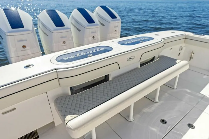 Slide: The Image of 2024 Valhalla V55 boat with quad engines and cushioned seating. - 2