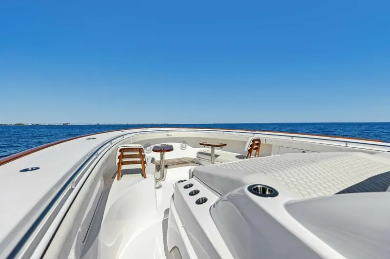 Slide: The Image of 2024 Valhalla V55 boat deck with seating, cruising on open water. - 20