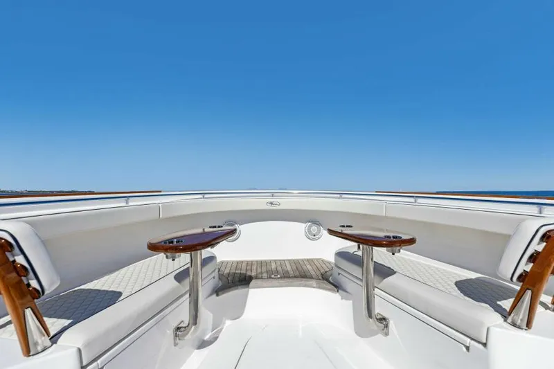 Slide: The Image of 2024 Valhalla V55 boat deck with seating and tables under clear blue sky. - 21