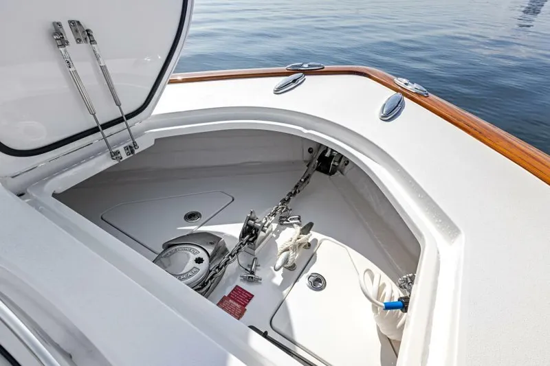 Slide: The Image of 2024 Valhalla V55 boat anchor compartment with chain and storage, featuring sleek design. - 22