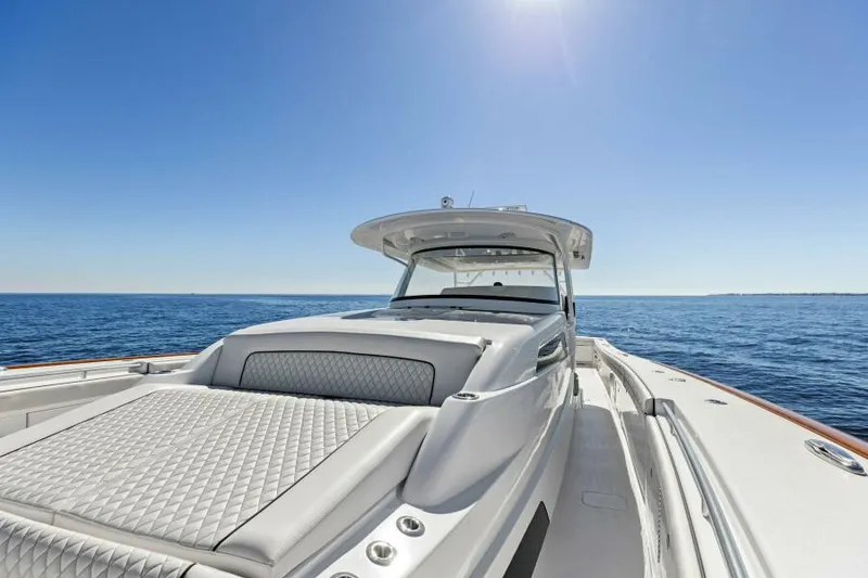 Slide: The Image of 2024 Valhalla Boatworks V55 on open sea under clear blue sky. - 25