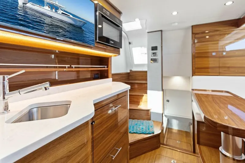Slide: The Image of Luxurious interior of 2024 Valhalla V55 boat with modern kitchen and wood finishes. - 27