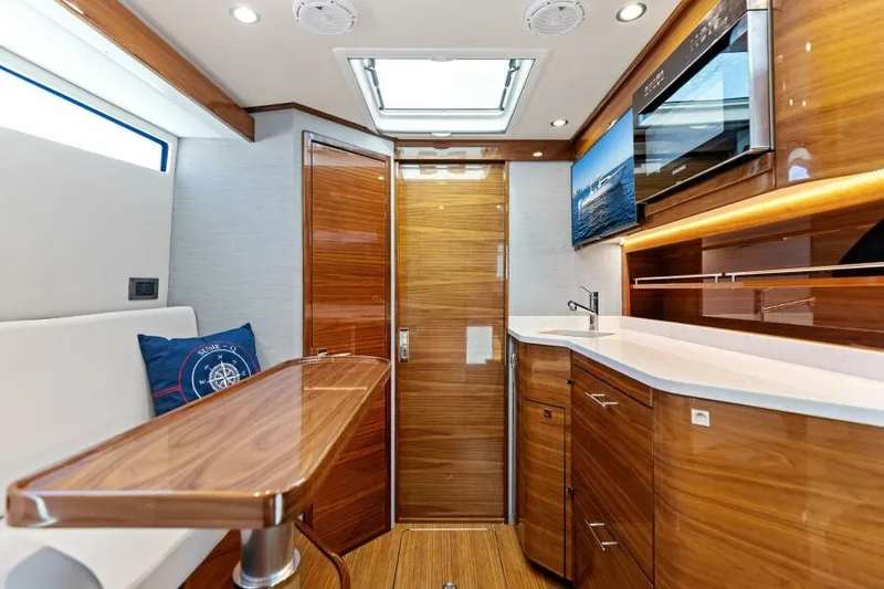 Slide: The Image of Luxurious interior of 2024 Valhalla V55 boat with wood finishes and modern amenities. - 28