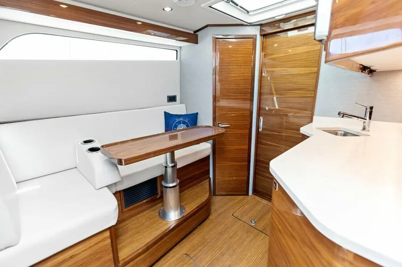 Slide: The Image of Luxurious interior of 2024 Valhalla V55 boat with wood finishes and modern amenities. - 29
