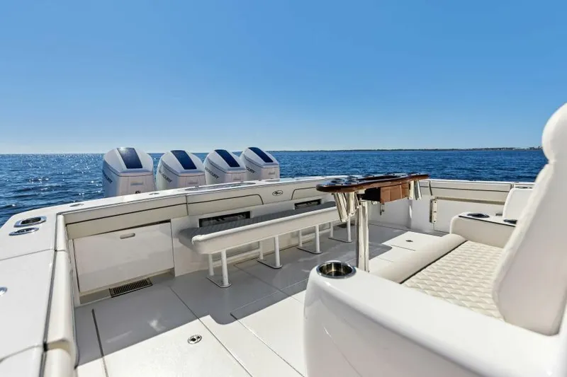 Slide: The Image of 2024 Valhalla V55 boat deck with seating, ocean view, and clear blue sky. - 3