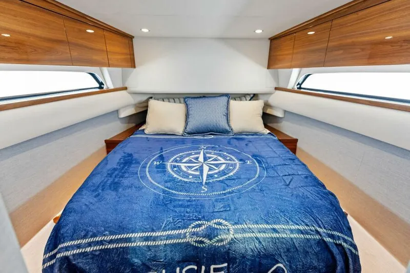 Slide: The Image of Luxurious 2024 Valhalla V55 boat cabin with cozy bed and nautical-themed decor. - 32