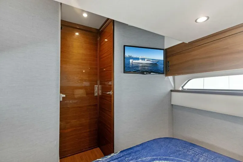 Slide: The Image of 2024 Valhalla V55 interior cabin with wood accents and wall-mounted TV. - 33
