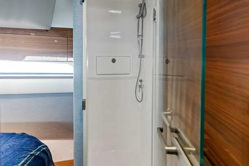Slide: The Image of 2024 Valhalla V55 boat interior with modern shower and cozy cabin. - 34