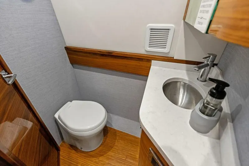 Slide: The Image of 2024 Valhalla V55 boat bathroom with modern sink and toilet. - 36