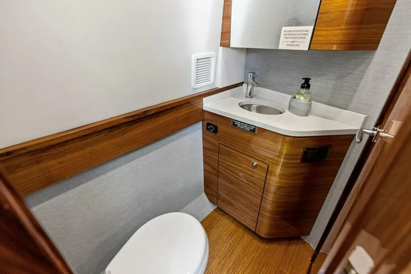 Slide: The Image of 2024 Valhalla V55 boat bathroom with modern wood finish and compact design. - 37