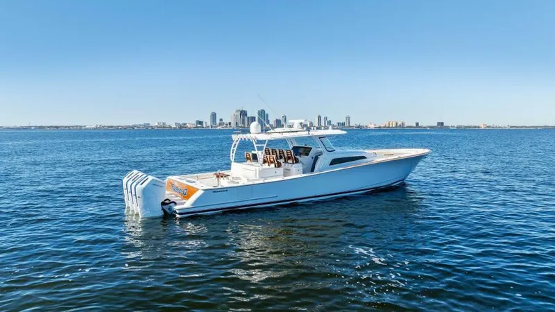 Slide: The Image of 2024 Valhalla V55 boat on open water with city skyline in background. - 41
