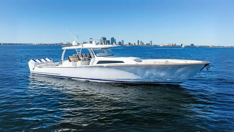 Slide: The Image of 2024 Valhalla Boatworks V55 on calm water with city skyline in background. - 54