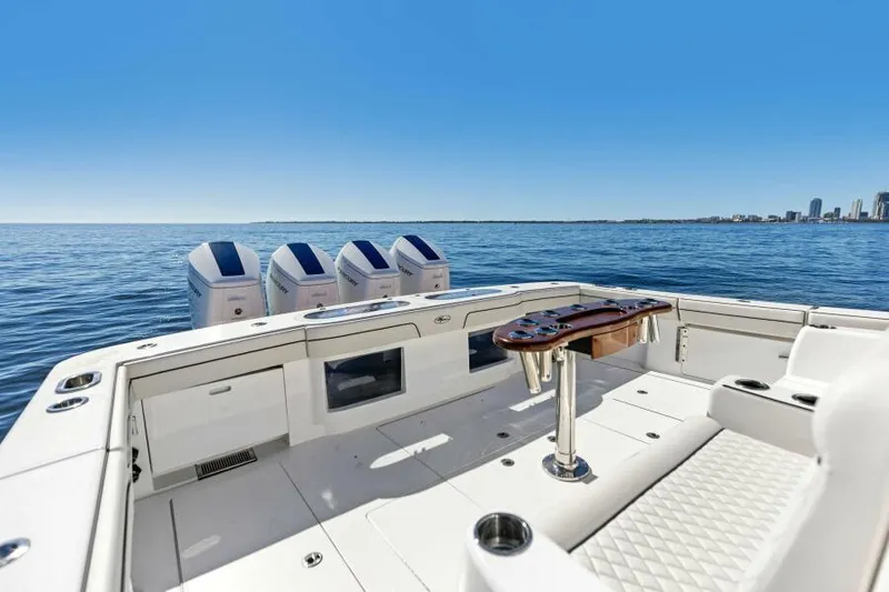 Slide: The Image of 2024 Valhalla V55 boat deck with four engines, ocean view, and city skyline. - 6