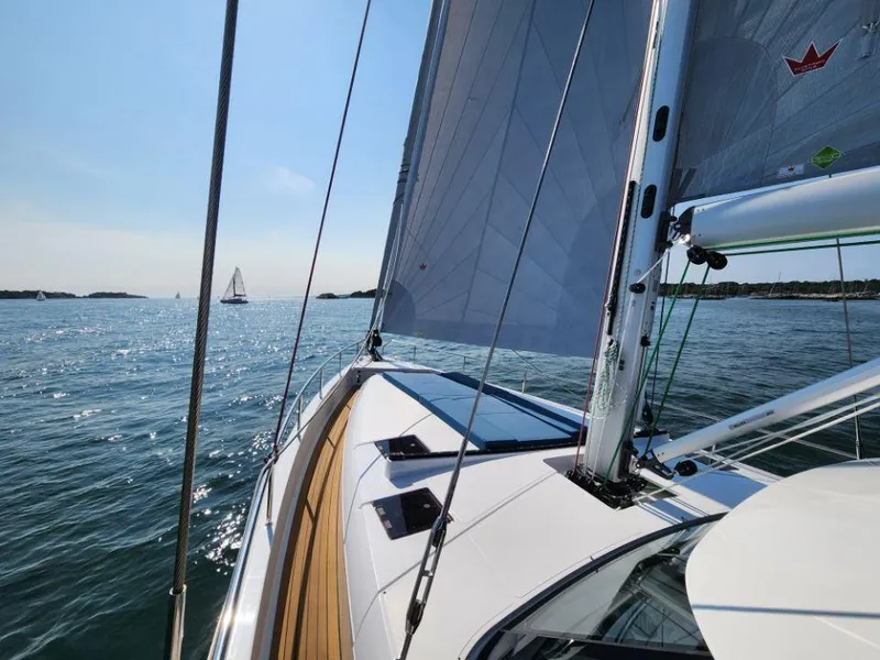 Slide: The Image of Sailing on a 2025 Moody 48 DS yacht, clear skies, calm waters. - 12