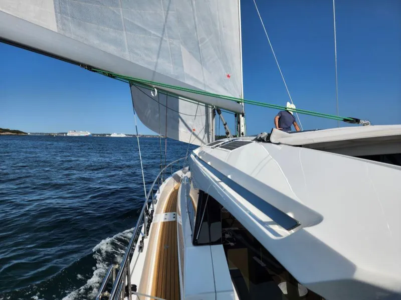 Slide: The Image of Sailing on a 2025 Moody 48 DS yacht in clear blue waters. - 13