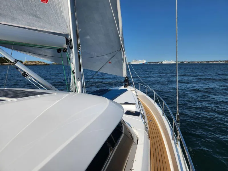 Slide: The Image of Sailing on a 2025 Moody 48 DS yacht with clear blue skies and calm waters. - 14