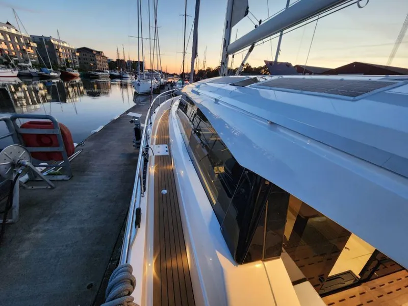 Slide: The Image of Moody 48 DS yacht docked at sunset, showcasing sleek design and modern features. - 22