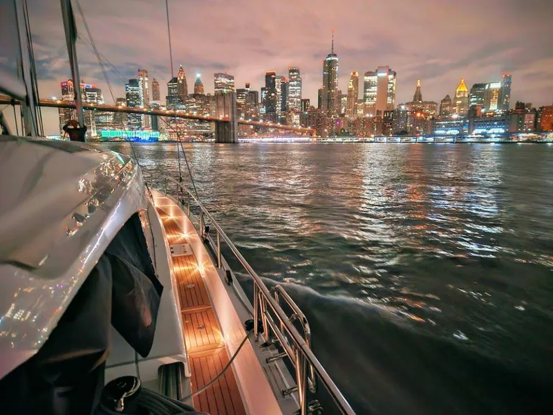 Slide: The Image of Sailing yacht Moody 48 DS, 2025, with city skyline and illuminated waterfront at dusk. - 23