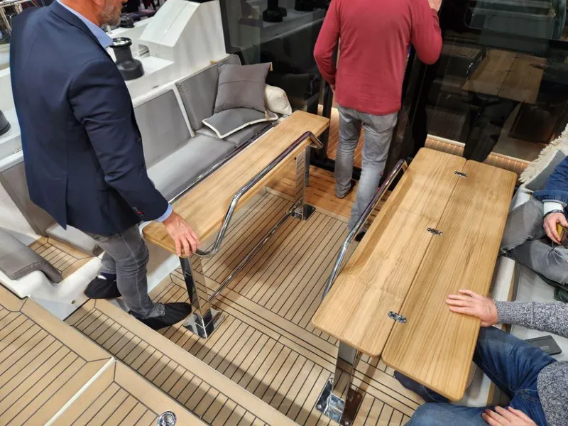 Slide: The Image of Interior of 2025 Moody 48 DS yacht with wooden tables and seating area. - 27