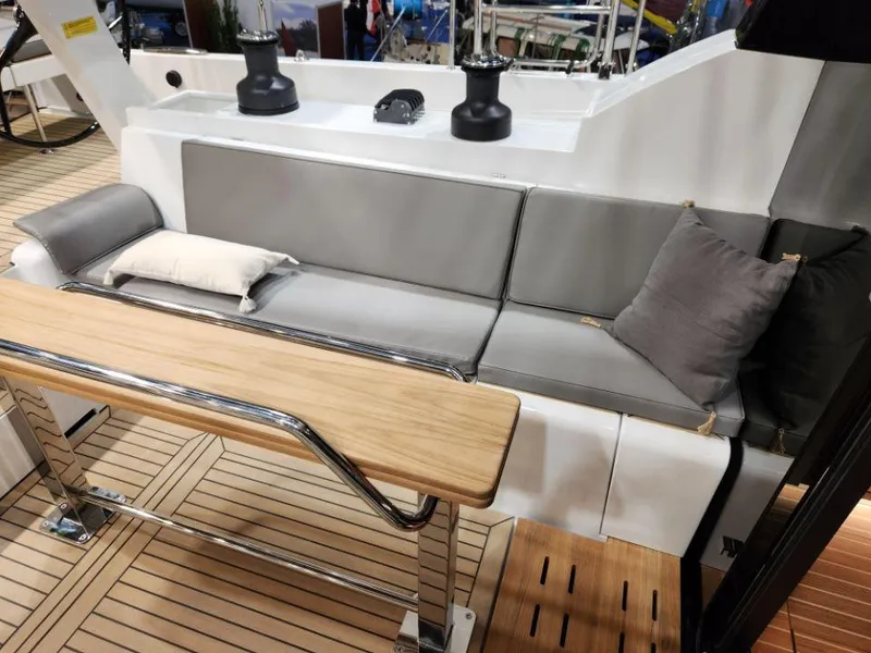 Slide: The Image of Luxurious seating area on 2025 Moody 48 DS yacht with wooden table and cushions. - 28