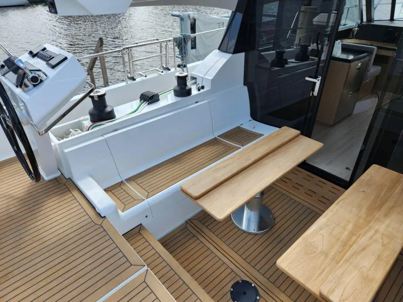 Slide: The Image of Luxurious 2025 Moody 48 DS yacht deck with seating and helm station. - 30