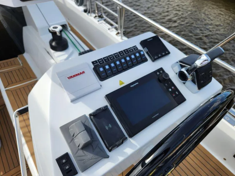 Slide: The Image of Helm of 2025 Moody 48 DS yacht with navigation controls and Yanmar engine panel. - 31