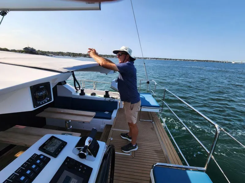 Slide: The Image of Man sailing on a 2025 Moody 48 DS yacht, enjoying a sunny day at sea. - 35