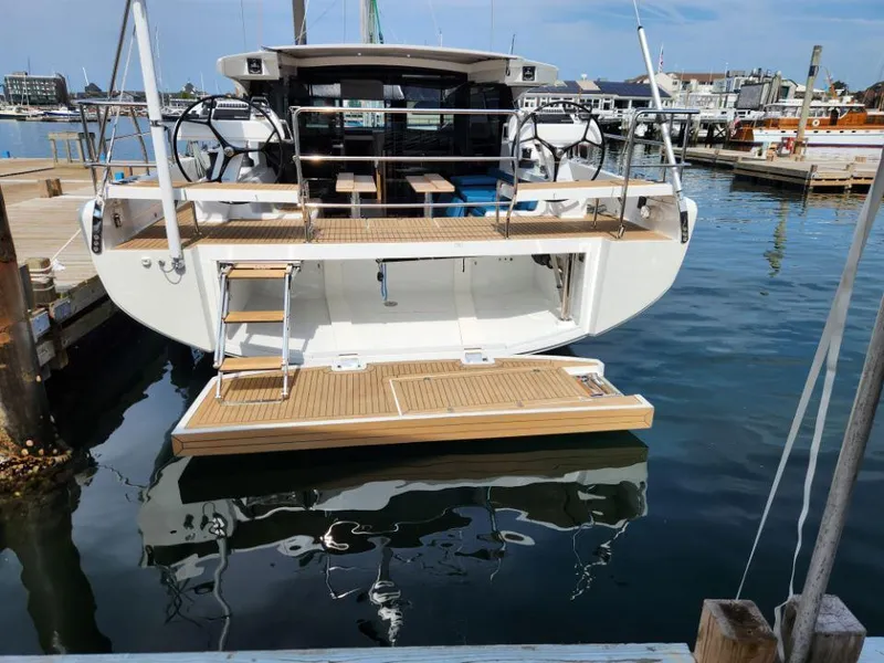 Slide: The Image of Sleek 2025 Moody 48 DS yacht docked at marina, showcasing modern design and spacious deck. - 37