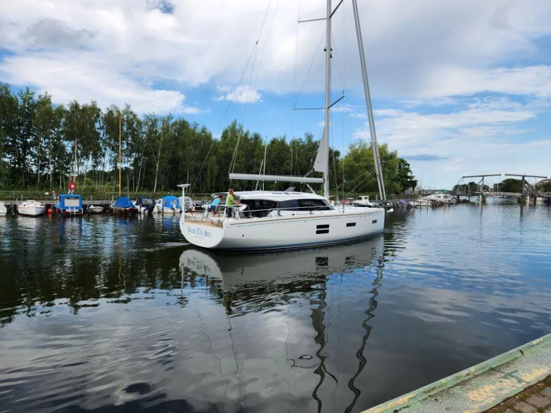 Slide: The Image of Sailing yacht Moody 48 DS 2025 on calm waters near a marina. - 4