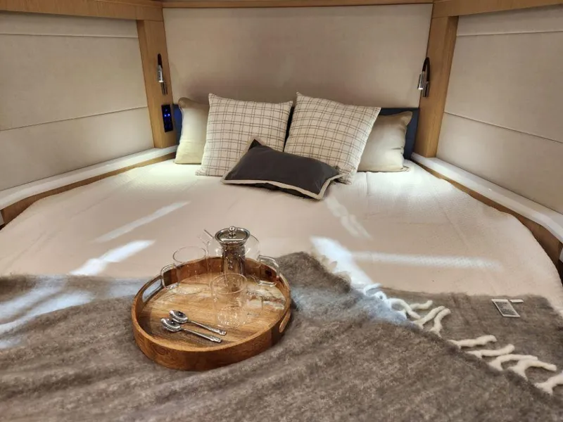Slide: The Image of Luxurious cabin interior of 2025 Moody 48 DS yacht with cozy bedding and elegant decor. - 43