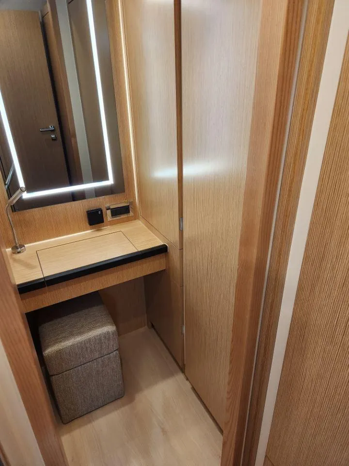 Slide: The Image of Modern interior of 2025 Moody 48 DS yacht with sleek wooden finishes and illuminated mirror. - 46