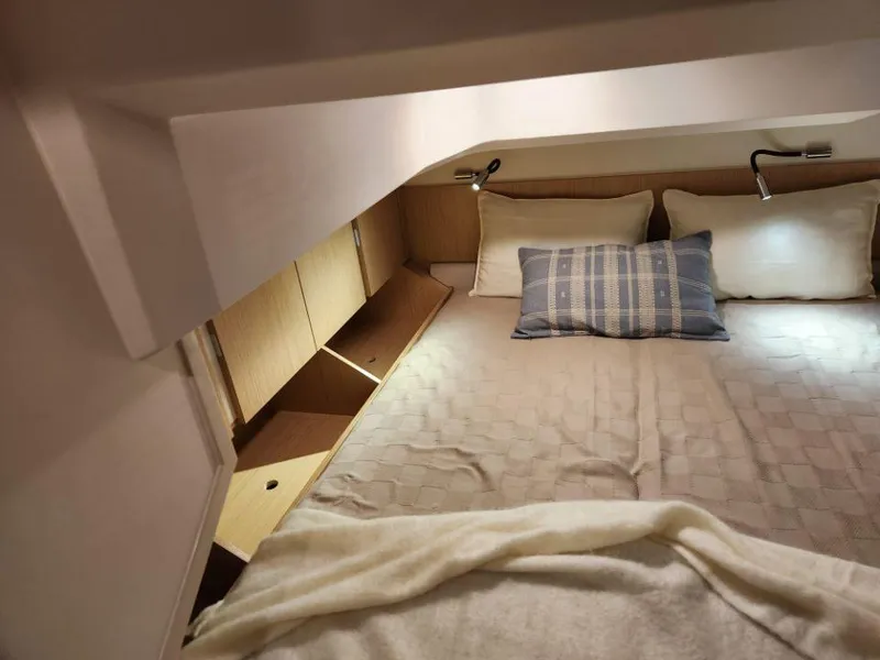 Slide: The Image of Cozy bedroom interior of 2025 Moody 48 DS yacht with modern lighting and storage. - 48