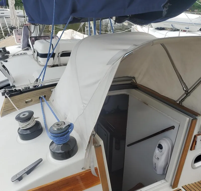 Slide: The Image of 1984 Beneteau First 42 sailboat cockpit with winches and cabin entrance. - 10