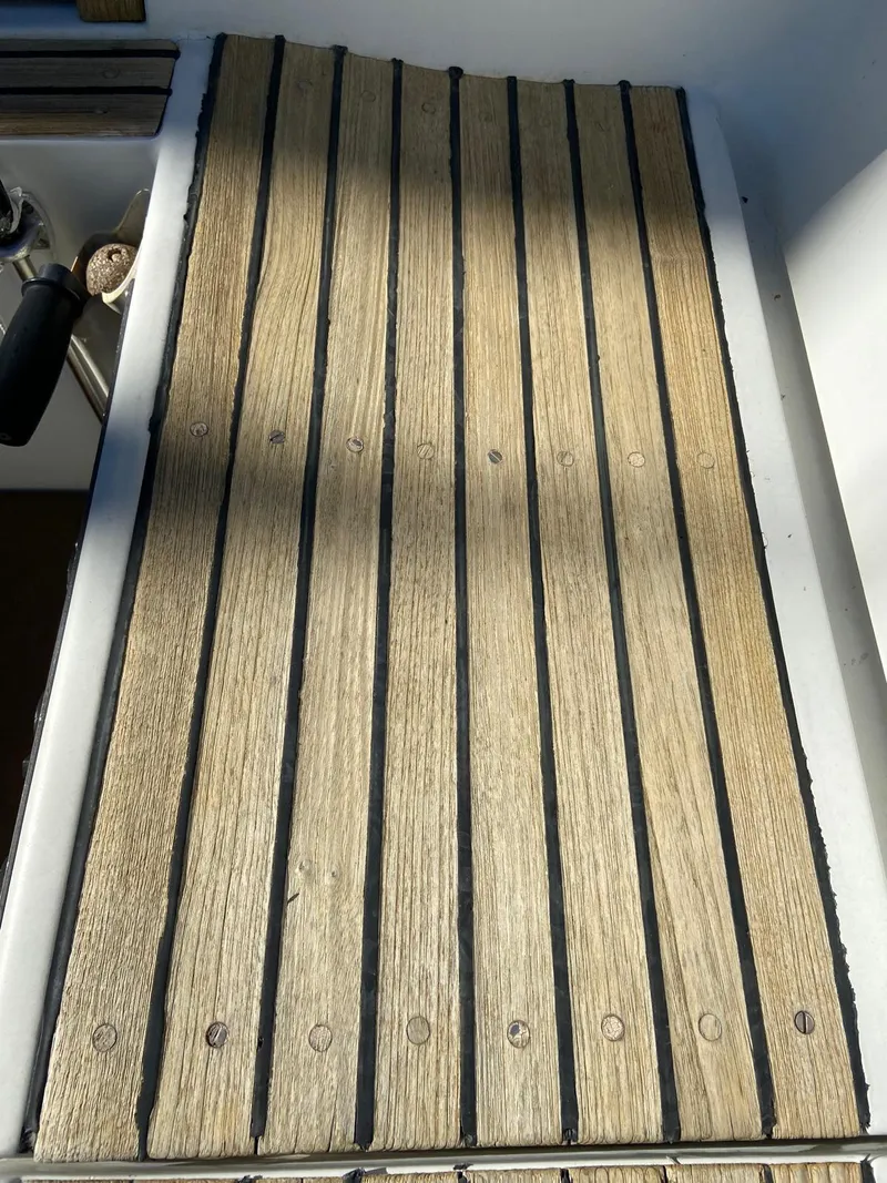 Slide: The Image of Teak deck of 1984 Beneteau First 42 sailboat, showing wood grain and fasteners. - 15