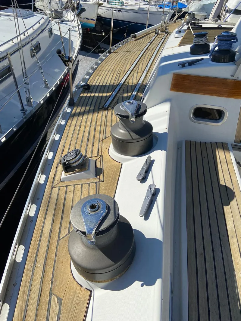Slide: The Image of 1984 Beneteau First 42 sailboat deck with winches and teak wood finish. - 18