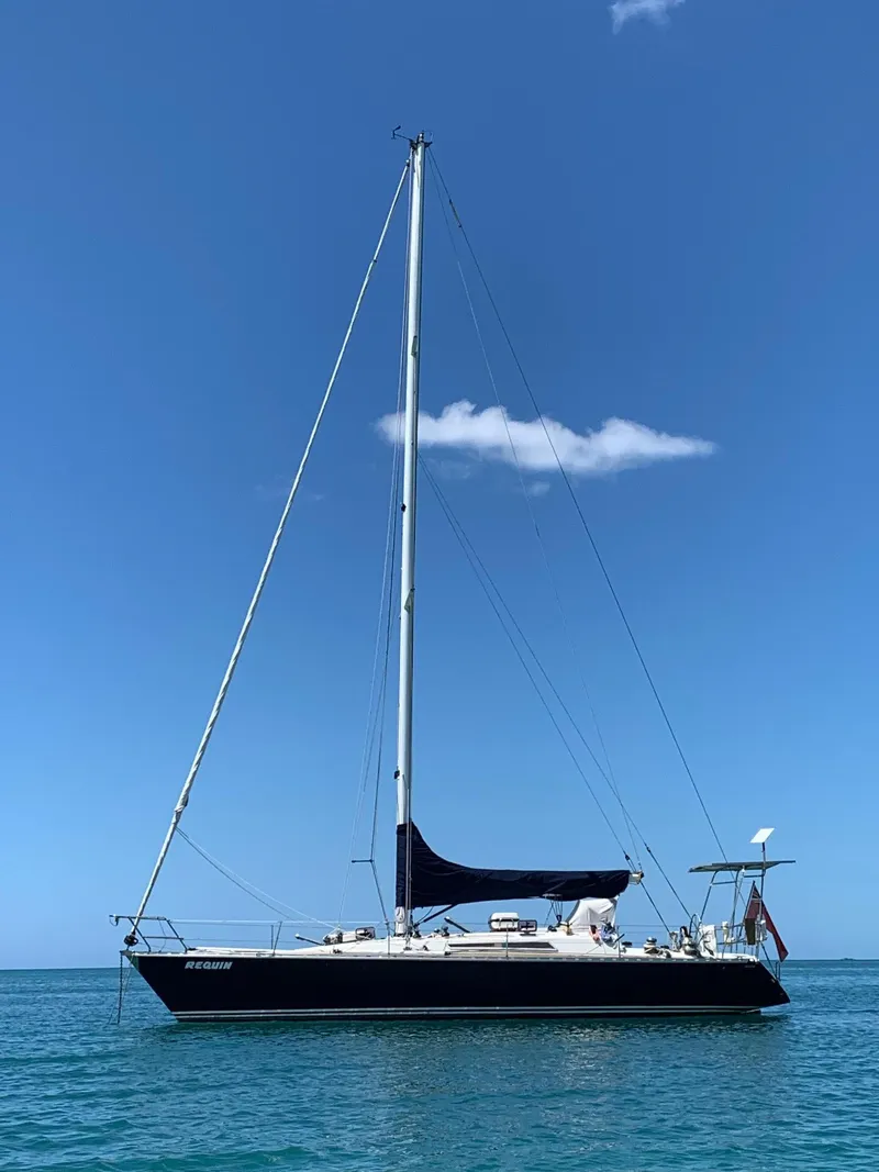 Slide: The Image of 1984 Beneteau First 42 sailboat on calm blue water under clear sky. - 3