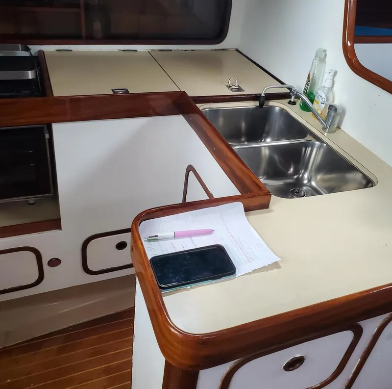 Slide: The Image of Interior of 1984 Beneteau First 42 sailboat kitchen with sink and countertop. - 32