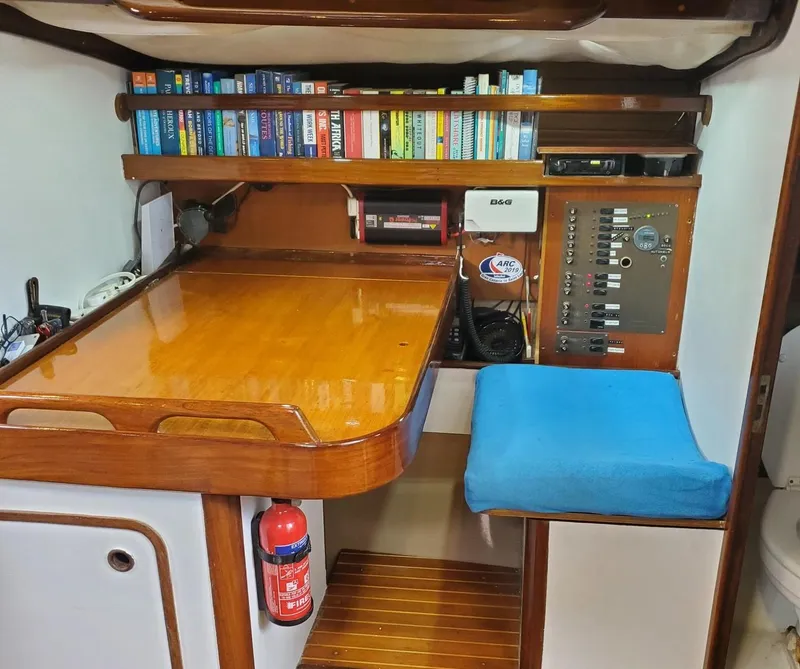Slide: The Image of Navigation station in 1984 Beneteau First 42 sailboat with books and control panel. - 40