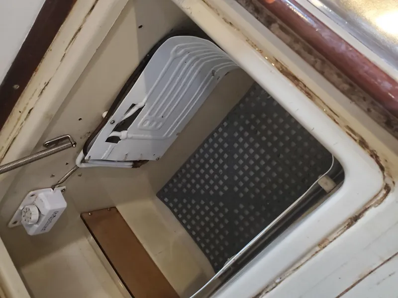 Slide: The Image of Interior compartment of 1984 Beneteau First 42 sailboat, showing storage space and equipment. - 43