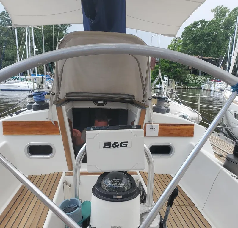 Slide: The Image of Cockpit of 1984 Beneteau First 42 sailboat with steering wheel and navigation equipment. - 9