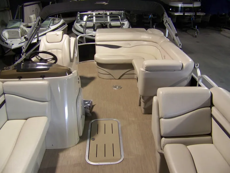 Slide: The Image of Interior of a 2018 Bennington 21SL pontoon boat with beige seating and helm. - 3