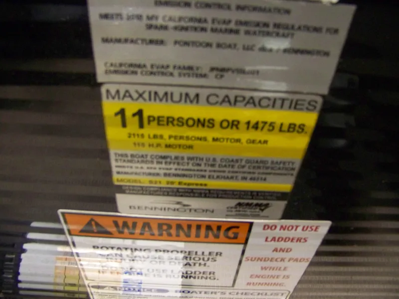 Slide: The Image of Capacity and warning labels on a 2018 Bennington 21SL boat, indicating 11-person or 1475 lbs limit. - 5